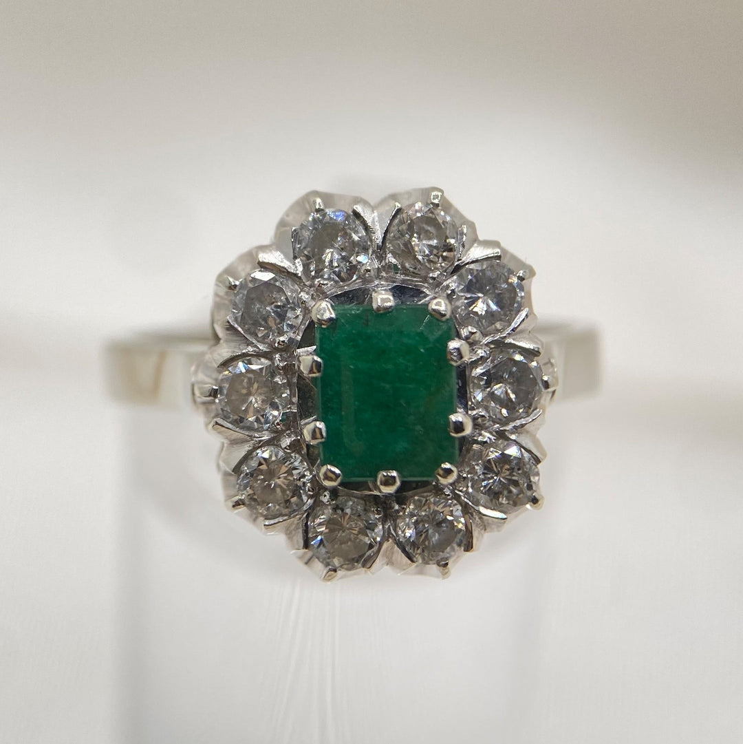 Vintage Weißgoldring 585 mit grünem achtkant‑Smaragd ca. 0,75 ct und zehn funkelnden Diamanten im Rundschliff, klassisches „Lädiertes Zauberwerk“‑Design aus der Mitte des 20. Jahrhunderts
