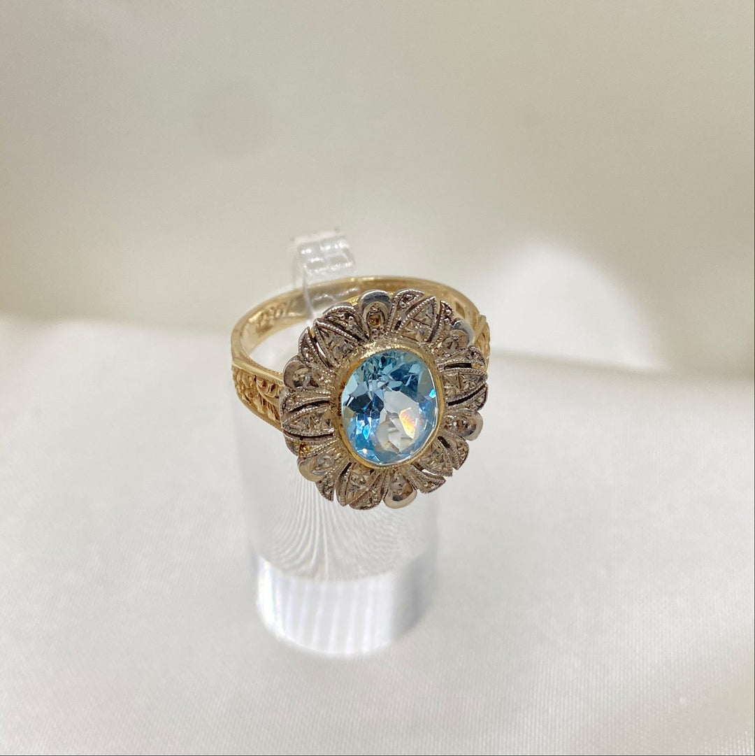 Detailaufnahme des intensiven blauen Topas‑Steins im Gelbgoldring mit Diamanten, lebhafte Farbe und feine Fassung