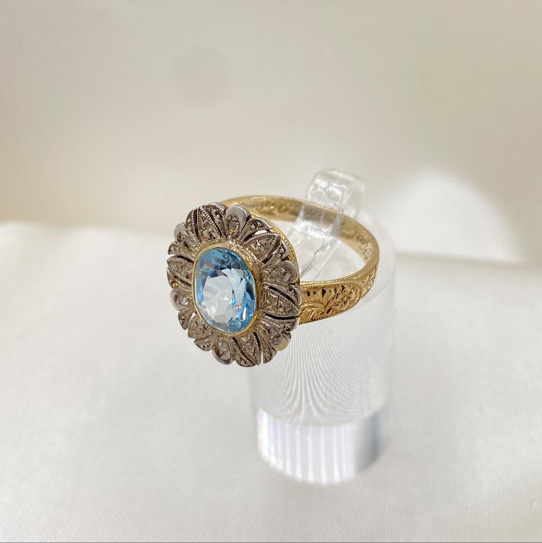 Nahaufnahme der funkelnden Diamanten im Gelbgoldring mit blauem Topas, präzise Körnerfassung und Brillanz