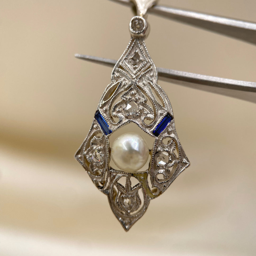 Detailaufnahme der feinen Zuchtperle im Art‑Déco‑Anhänger aus Gelbgold, kontrastreiche Edelstein‑Präsentation