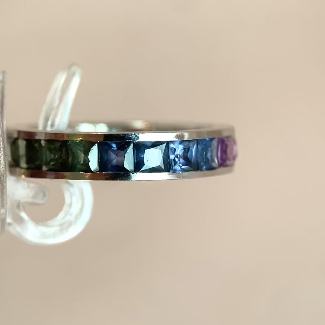 Modern white gold ring with princess-cut colored sapphires